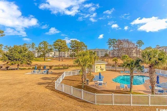 view of swimming pool with a yard and a patio area