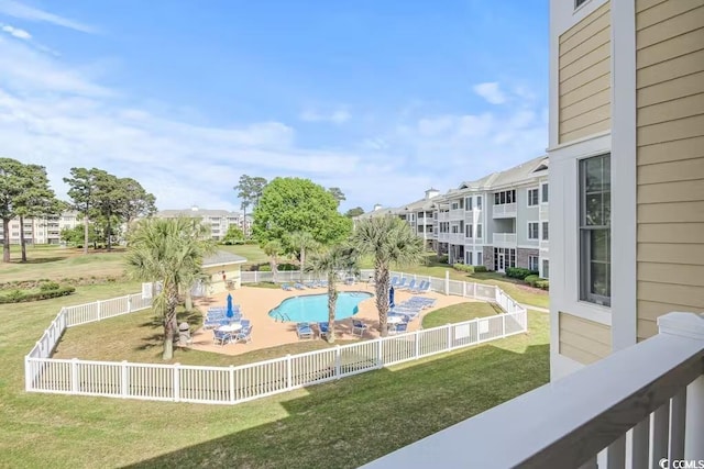 view of home's community featuring a yard and a swimming pool