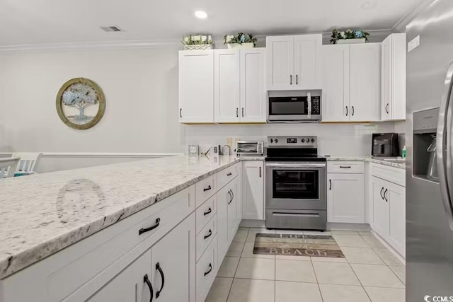 kitchen featuring light stone counters, crown molding, white cabinets, and appliances with stainless steel finishes