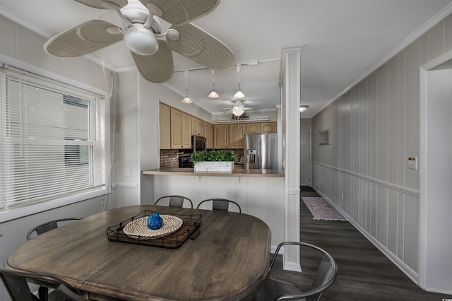 dining space with dark hardwood / wood-style flooring, ornamental molding, and ceiling fan