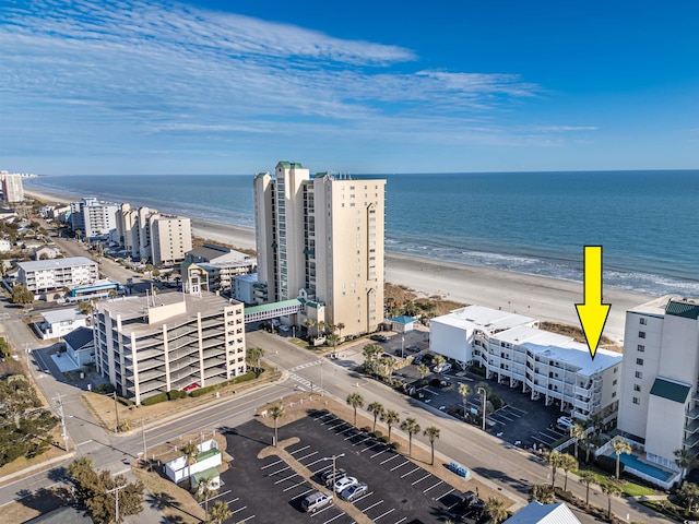 bird's eye view featuring a water view and a view of the beach