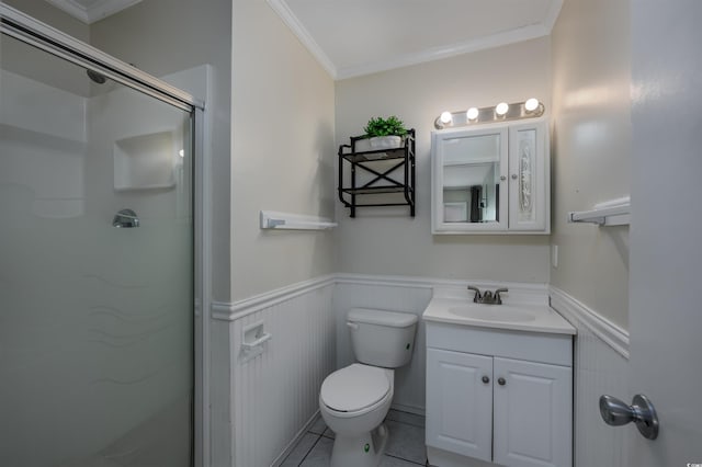 bathroom featuring tile patterned flooring, ornamental molding, vanity, toilet, and a shower with door