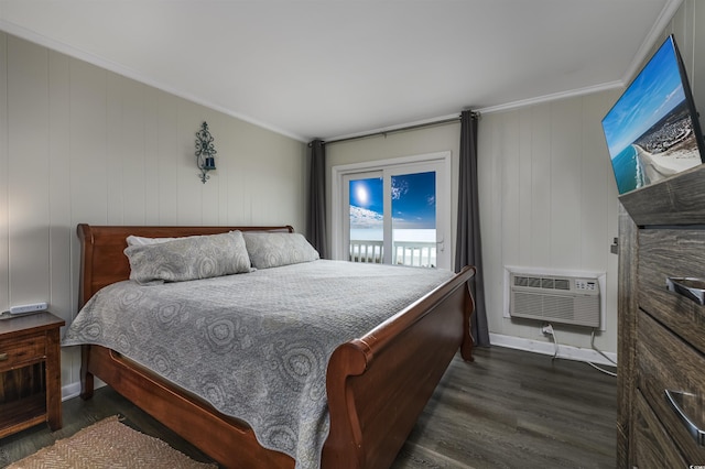 bedroom featuring dark wood-type flooring, ornamental molding, access to exterior, and a wall unit AC