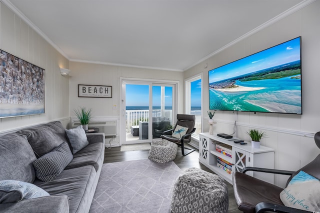 living room with hardwood / wood-style flooring, crown molding, and a wall mounted AC