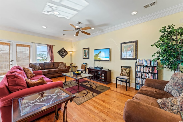 living room with crown molding, hardwood / wood-style floors, and ceiling fan