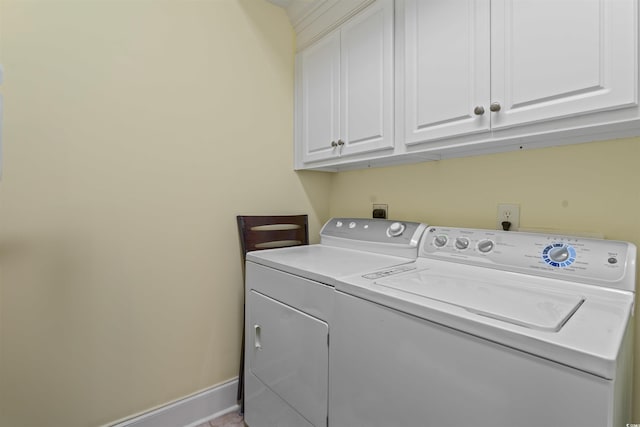 washroom featuring washer and clothes dryer and cabinets