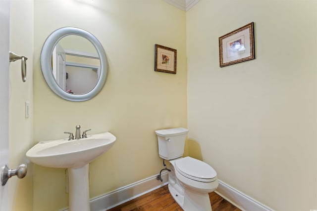 bathroom featuring hardwood / wood-style flooring and toilet