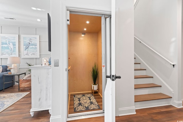 interior space featuring hardwood / wood-style flooring and elevator