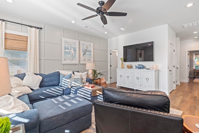 living room featuring ceiling fan and light wood-type flooring