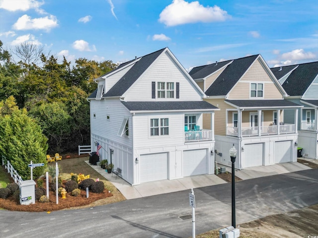 view of front of property featuring a balcony and a garage