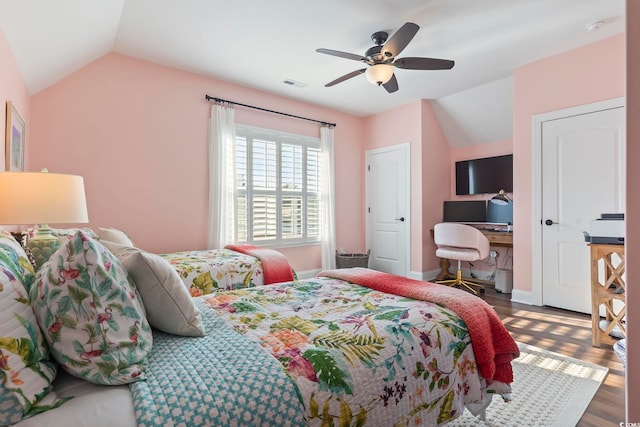 bedroom featuring vaulted ceiling, dark wood-type flooring, and ceiling fan