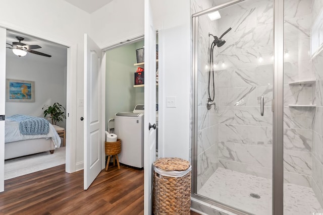 bathroom featuring ceiling fan, washer / clothes dryer, an enclosed shower, and hardwood / wood-style floors