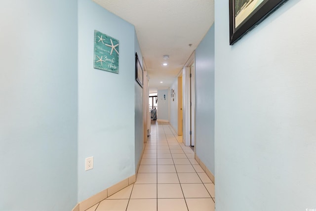 corridor featuring light tile patterned floors