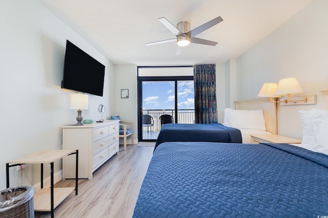 bedroom with ceiling fan, light wood-type flooring, a textured ceiling, and access to outside