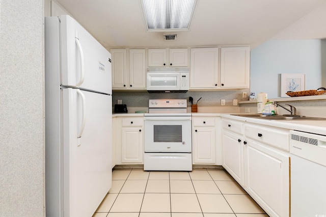 kitchen with white cabinetry, white appliances, sink, and light tile patterned floors