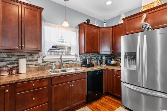 kitchen featuring tasteful backsplash, black dishwasher, dark wood-style floors, stainless steel refrigerator with ice dispenser, and a sink