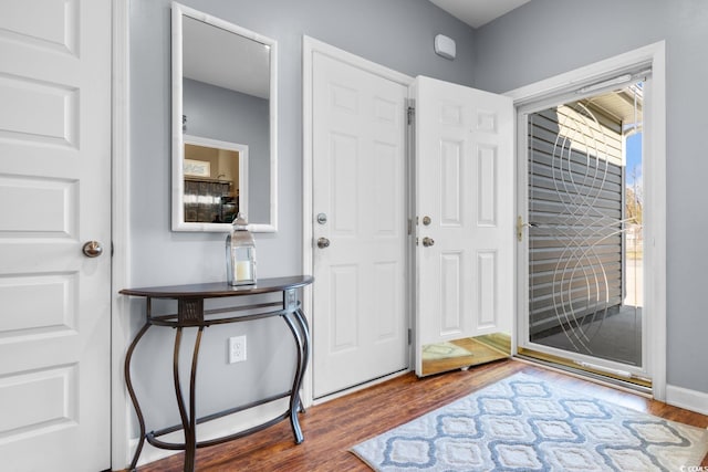 foyer entrance featuring wood finished floors and baseboards