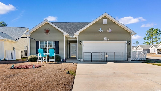 view of front of home with an attached garage, driveway, and fence