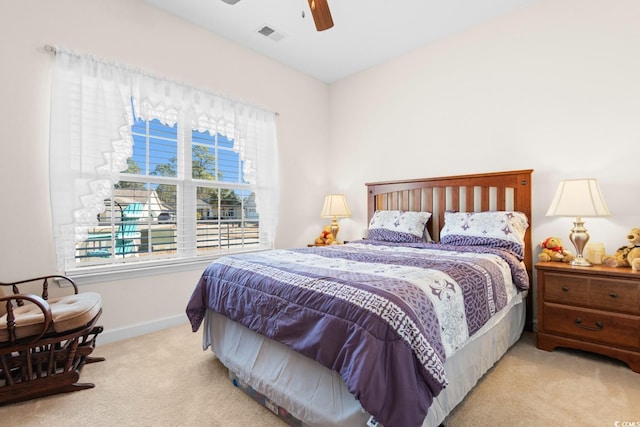 bedroom with a ceiling fan, carpet flooring, visible vents, and baseboards