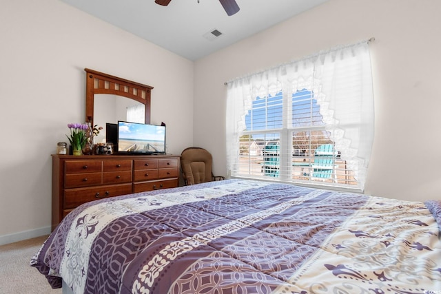 carpeted bedroom with visible vents, ceiling fan, and baseboards