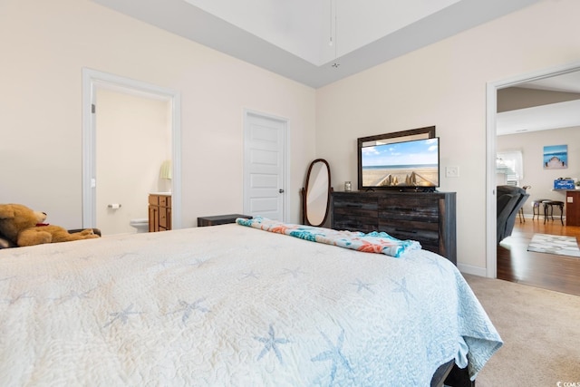 bedroom featuring baseboards, carpet flooring, and ensuite bath