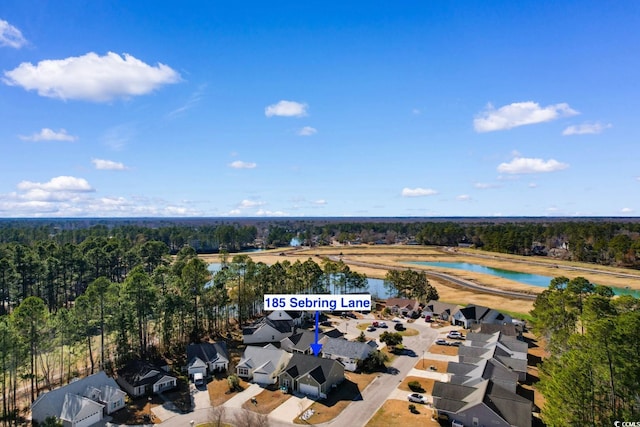 bird's eye view featuring a residential view, a water view, and a view of trees