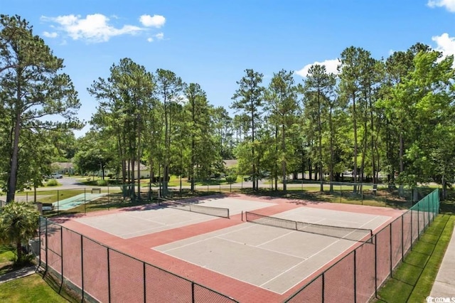 view of sport court featuring fence