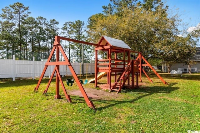 view of play area with fence and a yard