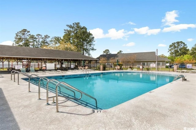 pool with fence and a patio