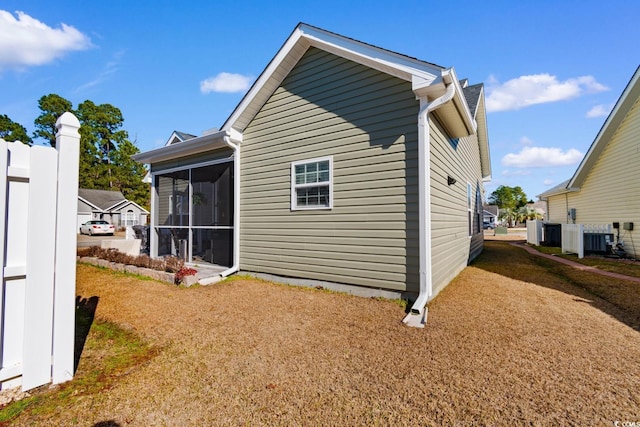 back of property with a sunroom and cooling unit