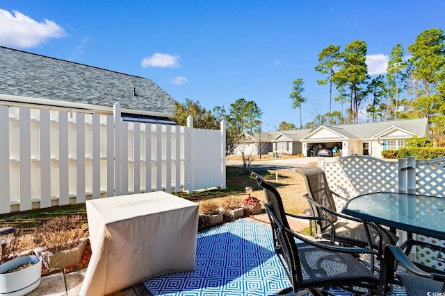 exterior space with a patio area, fence, and outdoor dining space