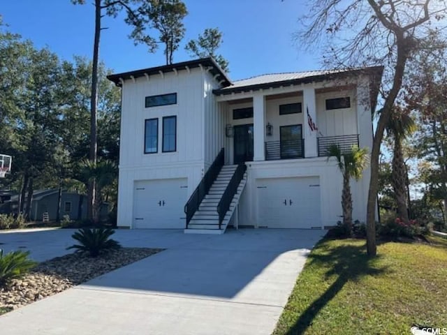 429 Harbour View Dr, Myrtle Beach, SC 29579 - view of front of house featuring board and batten siding, stairs, an attached garage, and driveway