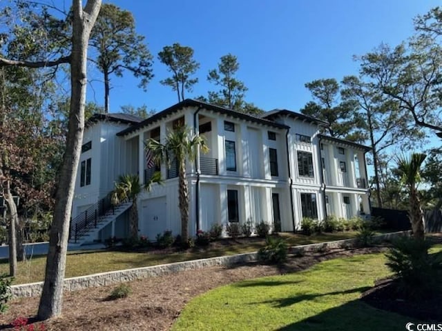 429 Harbour View Dr, Myrtle Beach, SC 29579 - italianate home featuring a front yard and an attached garage