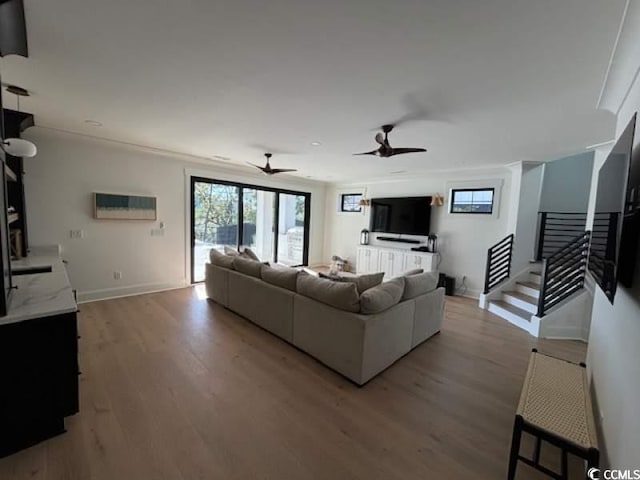 429 Harbour View Dr, Myrtle Beach, SC 29579 - living area featuring light wood-style flooring, stairs, ceiling fan, and baseboards