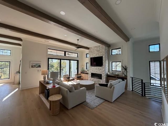 429 Harbour View Dr, Myrtle Beach, SC 29579 - living area with plenty of natural light, wood finished floors, beamed ceiling, a stone fireplace, and baseboards