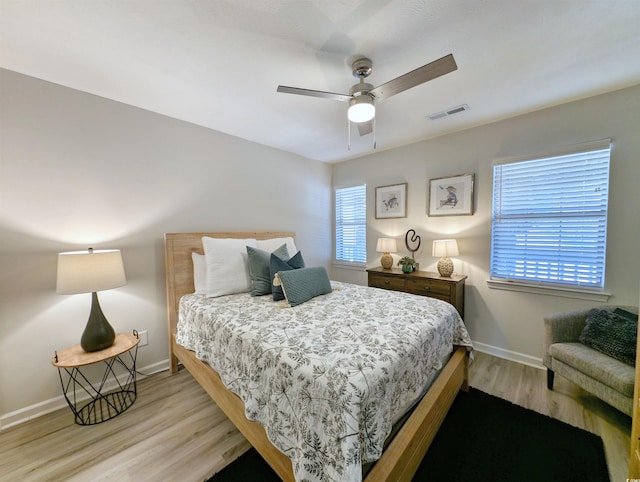 bedroom with ceiling fan and light hardwood / wood-style flooring