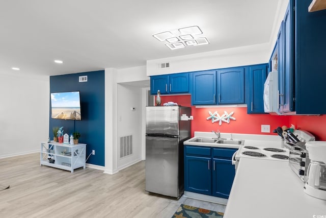 kitchen with blue cabinetry, white appliances, sink, and light hardwood / wood-style floors