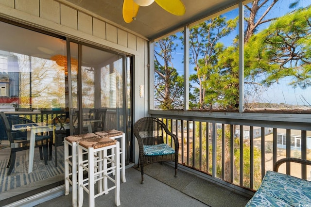 sunroom / solarium featuring ceiling fan