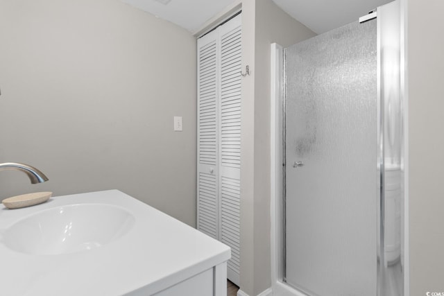 bathroom with vanity and a shower with door