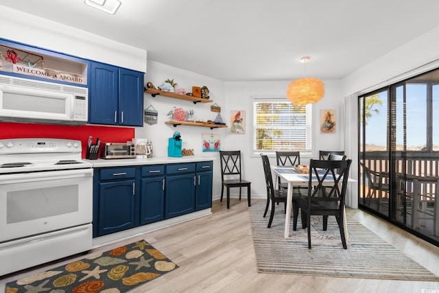 kitchen featuring blue cabinetry, white appliances, light hardwood / wood-style floors, and hanging light fixtures