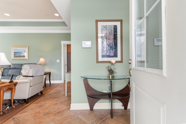 hall featuring crown molding and a raised ceiling