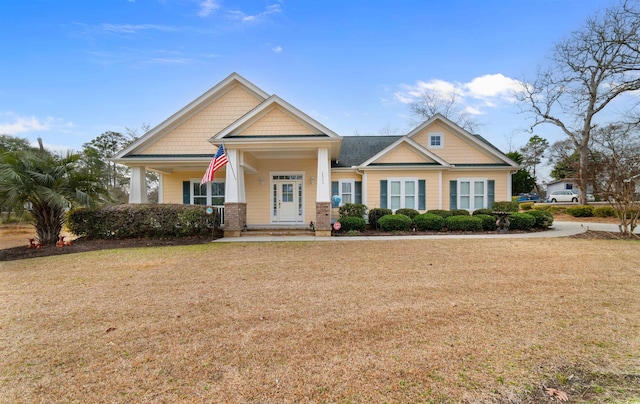 craftsman house with a front lawn and a porch