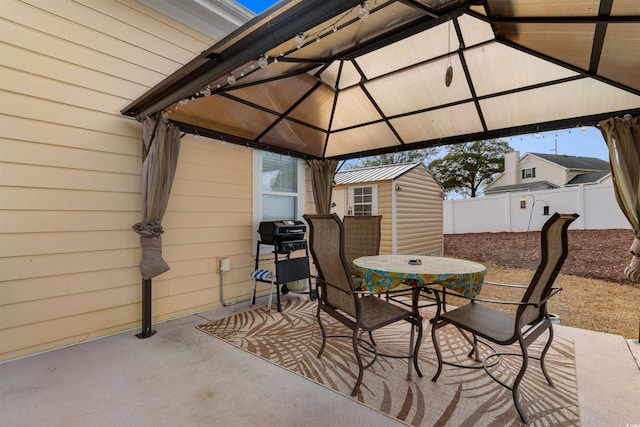 view of patio / terrace featuring a gazebo, a grill, and a shed