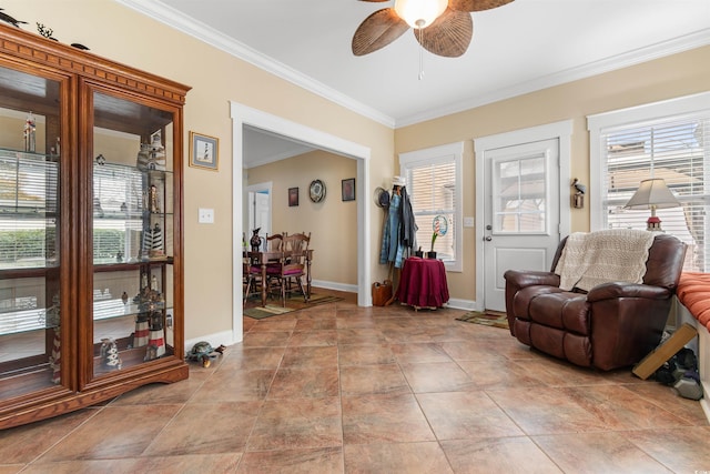 sitting room with ceiling fan and ornamental molding