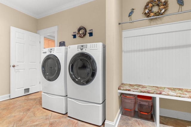 laundry room with ornamental molding and washer and dryer