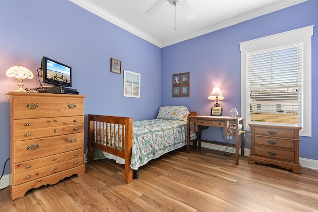 bedroom with crown molding, light hardwood / wood-style flooring, and ceiling fan