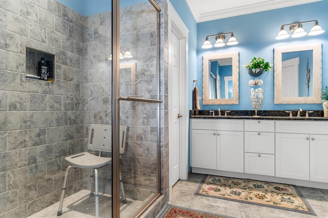 bathroom with vanity, crown molding, and walk in shower