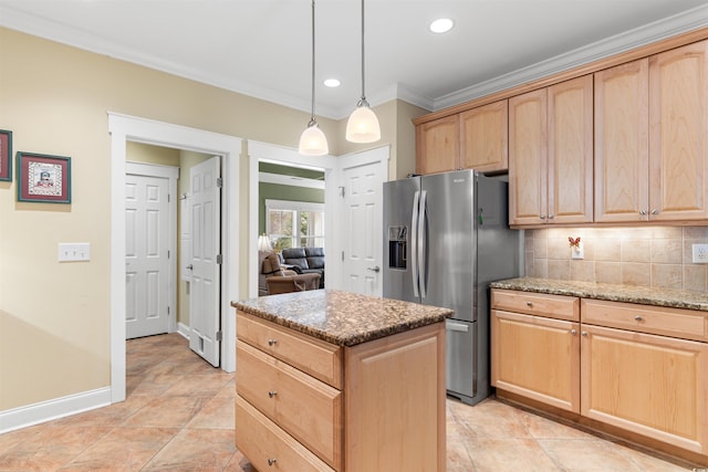 kitchen featuring stainless steel refrigerator with ice dispenser, a center island, light brown cabinetry, and light stone countertops