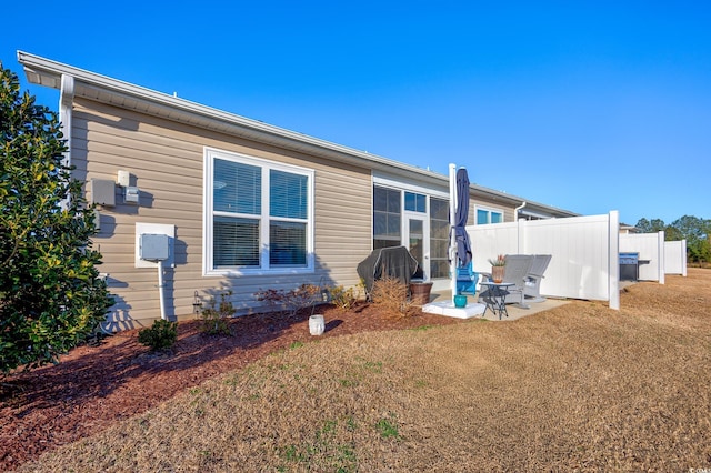 back of house featuring a yard and a patio area