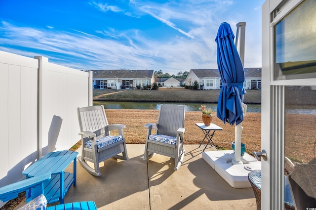 view of patio with a water view